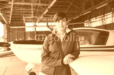 Female pilot posing in the hangar