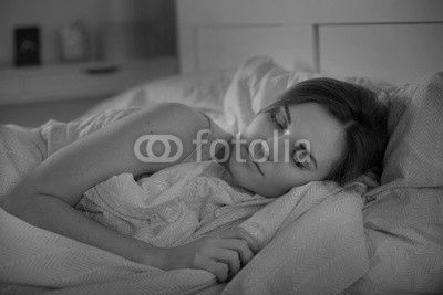 Girl peacefully sleeping in bed at night