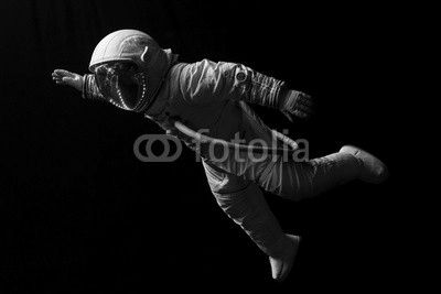 astronaut in space mission in the dark and space