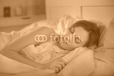 Girl peacefully sleeping in bed at night