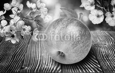 Apples with flowers on  wooden background