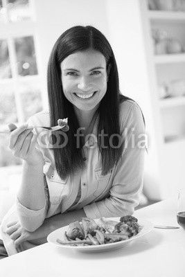 Portrait Of Woman Eating Healthy Meal In Kitchen