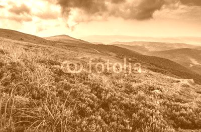 stones on the edge of mountain hillside at sunset