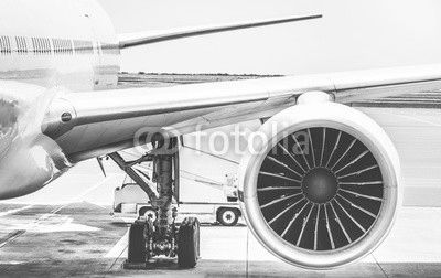 Detail of airplane engine wing at terminal gate before takeoff - Wanderlust travel concept around the world with air plane at international airport - Retro contrast filter with light blue color tones