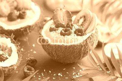 delicious mango  smoothie with fresh fruits and berries served in  coconut