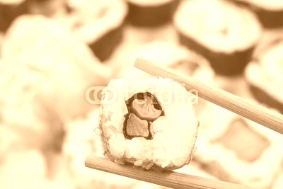 Sushi set. Chopsticks with portion of sushi