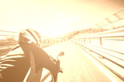 Motorcyclist riding his bike on the road at high speed