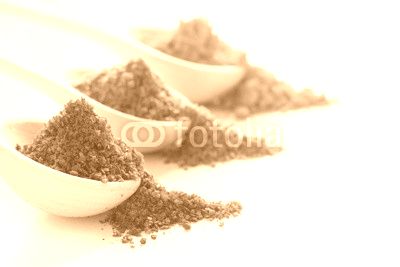 Spices in wooden spoons on a white background closeup