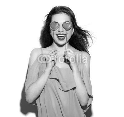 Valentines Day. Beauty joyful young fashion model girl with Valentine Heart shaped cookies in her hands