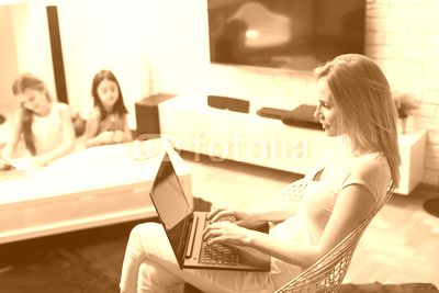 Mother and daughter in the room on the laptop at home