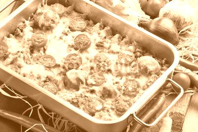 Casserole with rice meatballs and vegetables on wooden backgroun