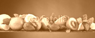 Ripe juicy fruits and peppermint with water drops