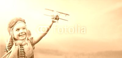 Freedom To Dream - Joyful Child Playing With Airplane Against The Sky
