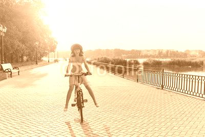 Young woman against nature background with bike