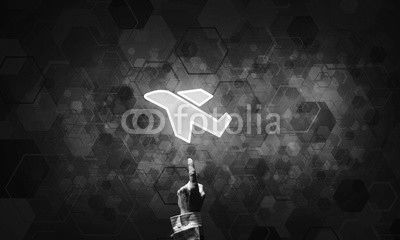 Airplane glowing icon touched with finger as online booking conc
