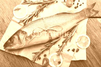 Fresh raw fish and food ingredients on table
