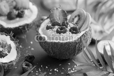 delicious mango  smoothie with fresh fruits and berries served in  coconut