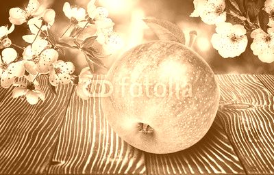 Apples with flowers on  wooden background