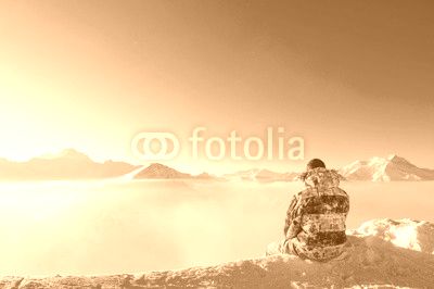 Man at mountains in clouds