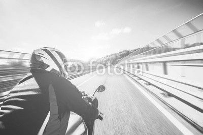 Motorcyclist riding his bike on the road at high speed