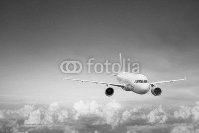 travel by plane, international flight, airplane flying in blue sky above the clouds