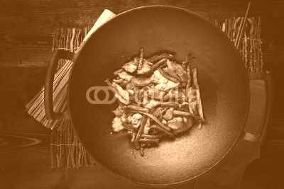 stir fried chicken in cast iron wok in flat lay composition