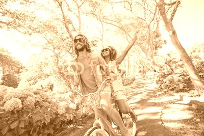 Couple having fun while cycling in the park