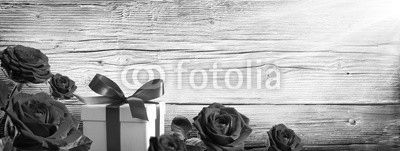 Gift Box And Roses On Vintage Wooden Background
