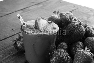 Fresh strawberry smoothie on wooden table