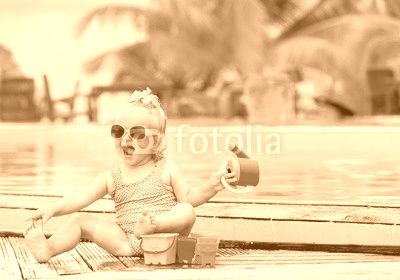 cute little girl playing on tropical beach