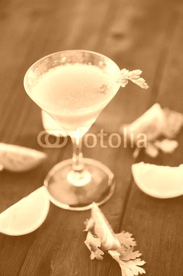 coctail with orange and tomato on black wooden table at blurred background