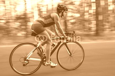 Athletic girl rides a bike