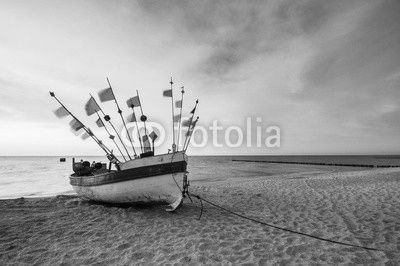 Vintage retro stylized photo of fishing boats on the sea beach