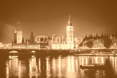 Iconic view Westminster with Big Ben, Houses of Parliament and Thames at Victoria Embankment lit up at night.