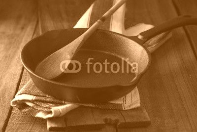 Cast iron frying pan on country rustic wooden/timber background