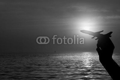 Silhouette of hand holding airplane , Travel concept