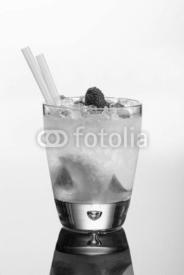 Raspberry vodka cocktail with lime sugar, raspberries and ice. On white background with reflection.