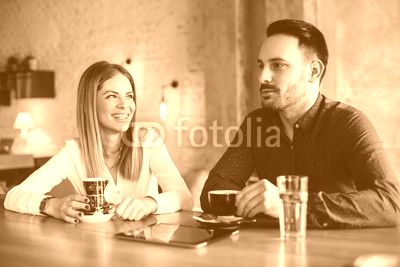 Young businesswoman and man on coffee break in cafe
