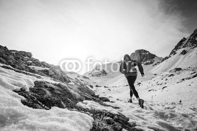 Man running on the snow on a mountain