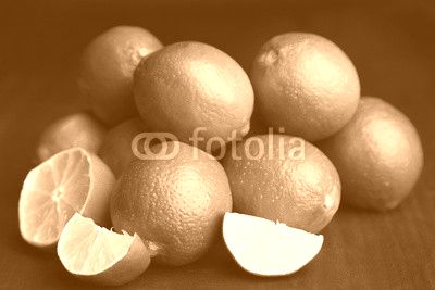 Fresh juicy limes on wooden table, on dark background