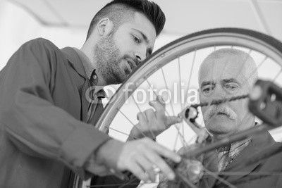 Men looking at bicycle chain