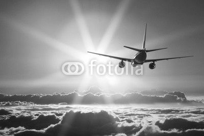 Plane is taking off at sunset
