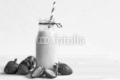 Strawberry smoothie or milkshake in a bottle with straw