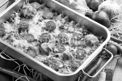 Casserole with rice meatballs and vegetables on wooden backgroun