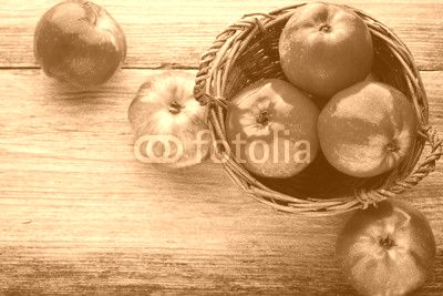 Ripe red apples on wooden background.