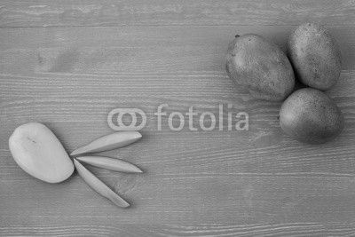 Three fresh mango and slices on a blue wooden background.