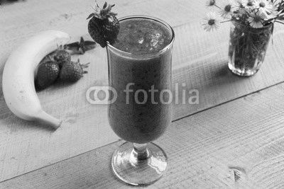 Strawberry banana smoothie in a glass on a table