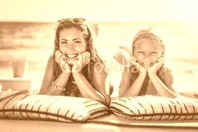 Mom And Daughter Posing At The Beach