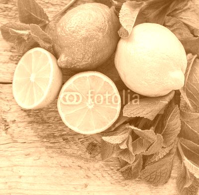 Juicy ripe citrus on an old wooden table - lime, lemon and mint