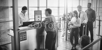 People waiting in queue at airplane counter